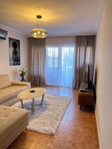 a living room with a couch and a table at Vista Petrovac in Petrovac na Moru