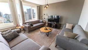 a living room with two couches and a tv at The Marmara Suadiye Residence in Istanbul