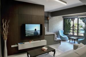 a living room with a tv on a wall at PIER21 house in Fethiye