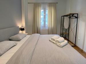 a bedroom with a large bed with towels on it at Luxury 1 Bedroom Flat in Athens