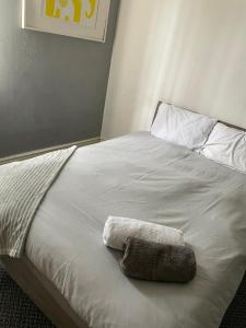 a white bed with a towel on top of it at Spacious Victorian Double Room 2 in Doncaster