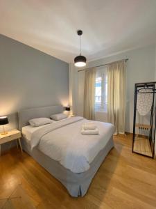 a bedroom with a large bed with two towels on it at Luxury 1 Bedroom Flat in Athens
