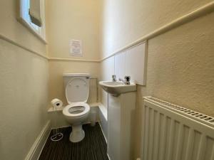 a small bathroom with a toilet and a sink at Spacious Victorian Double Room 2 in Doncaster