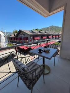 a patio with a table and chairs on a balcony at PIER21 house in Fethiye
