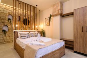 a bedroom with a large bed with towels on it at Teo Apartments in Georgioupolis