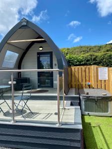 a dome house with a table and a chair at The Midi Pod in Aberystwyth