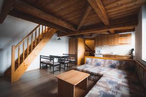 a living room with a couch and a table at Apartmány Jurica Boží Dar 86 in Boží Dar