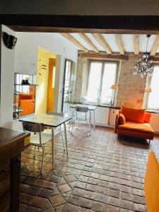 a living room with a table and chairs in a room at Les anges De Fleury in Fontainebleau +31 photos