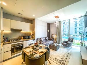Il comprend une cuisine et un salon avec une table et des chaises. dans l'établissement STAY BY LATINEM Luxury 1BR Holiday Home CV A207 near burj khalifa, à Dubaï