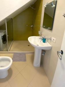 a bathroom with a sink and a toilet at Sunny Bay Apartments in Sarandë