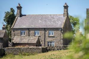 an old stone house on a hill at Knights Rest in Redmire