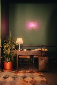 a room with a table with a lamp and a plant at Hotel Chateau Kvareli in Kvareli