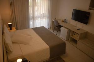 Giường trong phòng chung tại Vivá Barra Hotel Pousada