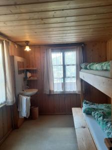 a room with two bunk beds and a sink at Berggasthaus Obbort in Linthal