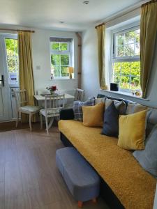 a living room with a couch and a table at Boots Cottage in Bude