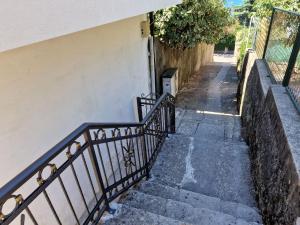 a stairway with a railing next to a building at Apartman Mediteran in Herceg-Novi