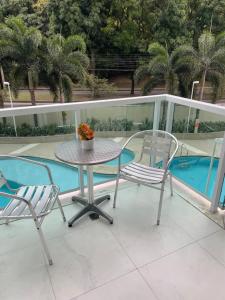 a table and two chairs sitting on a balcony at Rio stay flat rio centro, jeunesse, globo, rock in rio in Rio de Janeiro