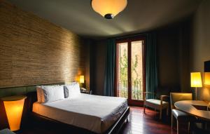 a bedroom with a large bed and a large window at Fonda Europa in Granollers