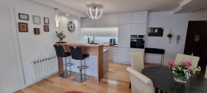 a kitchen and dining room with a table and chairs at Apartament w centrum Premium in Ustrzyki Dolne