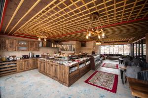 a large kitchen with a counter in a restaurant at Volare Stone Hotel in Nevşehir