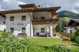 a large house with a balcony and a yard at App Sonne Nr 21 in Lutago