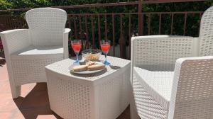 a table with two glasses of wine and a plate of food at Villa Giuseppina in Terracina