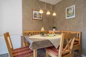 a dining room with a table with a bowl of fruit on it at Haus Schussenblick Og in Eriskirch