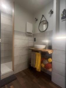 a bathroom with a sink and a mirror at GiTE ATYPIQUE AVEC PISCINE COUVERTE en saison in St Apollinaire De Rias