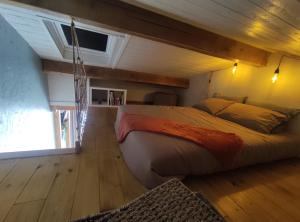 a bedroom with a large bed in a room at GiTE ATYPIQUE AVEC PISCINE COUVERTE en saison in St Apollinaire De Rias