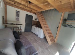 a room with a loft with a kitchen and a staircase at GiTE ATYPIQUE AVEC PISCINE COUVERTE en saison in St Apollinaire De Rias