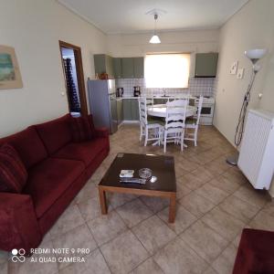 a living room with a couch and a table at ARETI 3 in Petalidi