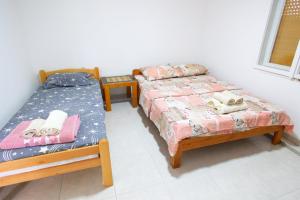 two beds sitting next to each other in a room at Apartman Rakić in Soko Banja