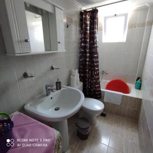 a bathroom with a sink and a toilet and a mirror at ARETI 3 in Petalidi +29 photos