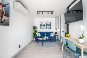 a living room with a blue couch and a table at Family Garden House with Free Private Parking & Playground in Rīga