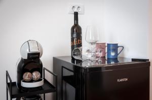 a table with a bottle of wine and a blender at Jazz Rooms and Apartments in Rovinj