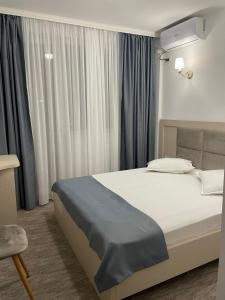 En eller flere senge i et værelse på Casa Alex