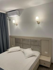 En eller flere senge i et værelse på Casa Alex