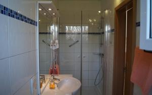 a bathroom with a shower and a sink and a shower at Ferienhaus große Krabbe in Neuharlingersiel