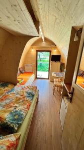 um pequeno quarto com duas camas e uma mesa em Tiny House Carlos em Stuer