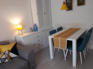 a living room with a table and chairs and a couch at Budva center apartmant in Budva