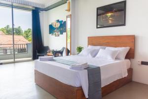 a bedroom with a large bed and a large window at Western sky in Negombo