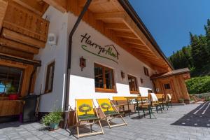 a group of chairs sitting outside of a building at Harrys Alm - Appartements in Haus im Ennstal