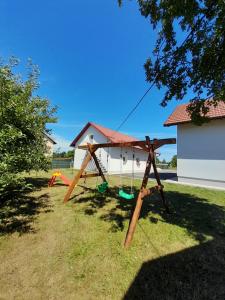a swing set in the yard of a house at Kuća za odmor Mirna in Gospić
