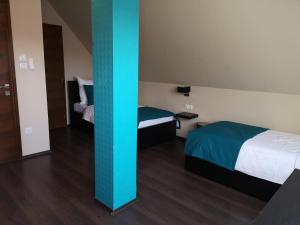 Postel nebo postele na pokoji v ubytování Parton Hotel & Bowling