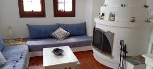 a living room with a couch and a fireplace at Villa Katerina in Platanias