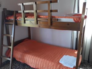 two bunk beds in a room with an orange mattress at Beach Bungalows in Kipseli