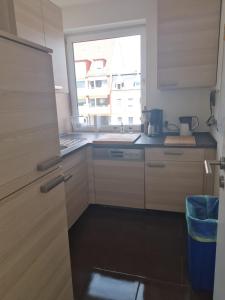 a small kitchen with a sink and a window at Im Herzen der Marzipanstadt in Lübeck