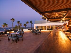 a restaurant on the beach with tables and chairs at Leonardo Crystal Cove Hotel & Spa – Adults only in Protaras +37 photos