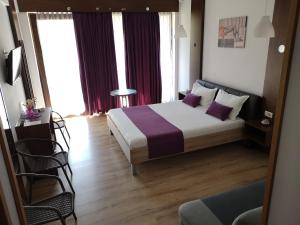 a bedroom with a large bed with purple pillows at Dream Resort (Adults only 14+) in Mamaia Nord