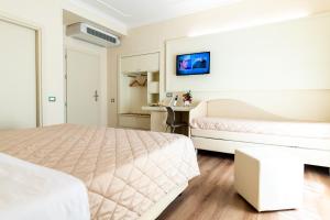 Postel nebo postele na pokoji v ubytování Hotel Corso